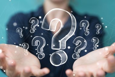 一名女商人用手捧著提出手繪的問號。 一名女商人用手捧著提出手繪的問號。